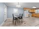 Kitchen and dining area featuring a glass table, tile floors, and a door to access the backyard at 464 Camp Rd, Burlington, NC 27217