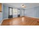 Sun-drenched living room with gleaming hardwood floors, ceiling fan, and large window at 464 Camp Rd, Burlington, NC 27217