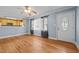 Bright living room with hardwood floors, a ceiling fan, and natural light from the front door window at 464 Camp Rd, Burlington, NC 27217