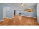 Spacious living room with hardwood floors, ceiling fan, and open access to the kitchen at 464 Camp Rd, Burlington, NC 27217