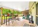 Back porch area with a bar, seating, and relaxing wooded views at 509 Stokes Rd, Graham, NC 27253