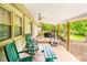 Covered back porch with seating, a swing, and scenic views at 509 Stokes Rd, Graham, NC 27253