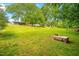 Spacious backyard featuring a wooden bench and ample green space for relaxation and recreation at 509 Stokes Rd, Graham, NC 27253