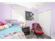 Cozy bedroom with a bed, draped with patterned fabric, featuring soft lighting and a comfortable seating area at 509 Stokes Rd, Graham, NC 27253