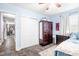 A bedroom with light blue walls has a comfortable bed, closet, and view to the home's living area at 509 Stokes Rd, Graham, NC 27253