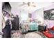 A cozy bedroom with lilac walls featuring a comfortable bed adorned with pillows, next to dark wood furnishings at 509 Stokes Rd, Graham, NC 27253