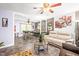 An open living room and dining room area with ceiling fans, modern flooring, and neutral paint at 509 Stokes Rd, Graham, NC 27253