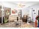 Comfortable living room with neutral furniture, ceiling fan, updated flooring, and natural light at 509 Stokes Rd, Graham, NC 27253