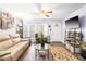 Bright living room with a comfortable sofa, recliner, ceiling fan, and natural light at 509 Stokes Rd, Graham, NC 27253