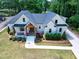 Aerial view of a charming home with a well-manicured lawn, beautiful landscaping, and inviting front porch at 512 Page St, Cary, NC 27511