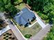 Aerial view showcases the home's backyard, driveway, and landscaping surrounded by lush trees at 512 Page St, Cary, NC 27511