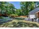 Large backyard featuring patio area, lush green lawn, and landscaped garden beds surrounded by a modern horizontal fence at 512 Page St, Cary, NC 27511