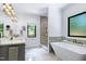 This luxury bathroom includes double sinks, modern lighting, soaking tub and glass shower at 512 Page St, Cary, NC 27511