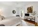 Bedroom with TV, wall art, decorative mirror, ceiling fan and natural light offers a tranquil and stylish retreat at 512 Page St, Cary, NC 27511
