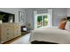 Bedroom featuring a large window with white curtains, light grey walls and hardwood floors at 512 Page St, Cary, NC 27511