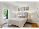 Bright bedroom features a neutral palette, a large window, and stylish decor creating a serene and inviting space at 512 Page St, Cary, NC 27511