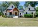 Beautiful two-story white home featuring a welcoming front porch, wood accents and an American flag at 512 Page St, Cary, NC 27511