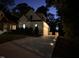 Elegant evening shot of the home's driveway leading to a garage, accented by landscape lighting at 512 Page St, Cary, NC 27511