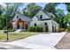 Charming white home with a spacious driveway, attached garage and manicured lawn with mature trees at 512 Page St, Cary, NC 27511