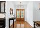 Welcoming foyer with hardwood floors, decorative lighting, and a view of the wooden double doors at 512 Page St, Cary, NC 27511