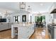 Open concept kitchen with island seating, dining area, and living room beyond at 512 Page St, Cary, NC 27511