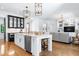 Open concept floorplan with kitchen island seating, dining, and adjacent living area at 512 Page St, Cary, NC 27511