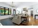 Spacious living room with large windows and view into kitchen and dining areas at 512 Page St, Cary, NC 27511