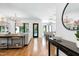 Open-concept living room with hardwood floors, modern chandeliers, and seamless transition to the kitchen at 512 Page St, Cary, NC 27511
