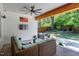 Inviting covered outdoor patio with ceiling fan, lounge seating, and grilling area overlooking the landscaped backyard at 512 Page St, Cary, NC 27511