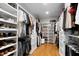 Spacious walk-in closet with custom shelving, hanging rods, and hardwood floors at 512 Page St, Cary, NC 27511