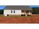 New construction home exterior featuring a wooden deck and unfinished landscaping at 519 Mulberry Rd, Spring Hope, NC 27882
