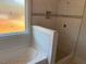 Bright bathroom with a tiled shower, niche, and a separate bathtub at 519 Mulberry Rd, Spring Hope, NC 27882