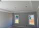Bedroom featuring tray ceilings, crown moulding, and windows providing natural light at 519 Mulberry Rd, Spring Hope, NC 27882
