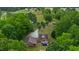 Picturesque aerial view of estate featuring lush trees, water feature, and residence with inviting in-ground pool at 5237 Christian Light Rd, Fuquay Varina, NC 27526