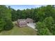 Expansive aerial view of a brick home nestled in a verdant, mature landscape at 5237 Christian Light Rd, Fuquay Varina, NC 27526