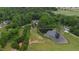 Expansive aerial view of estate featuring a large pond, fenced pastures, lush trees, and multiple outbuildings at 5237 Christian Light Rd, Fuquay Varina, NC 27526