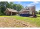 The backyard features brick walls, a green lawn and trees at 5237 Christian Light Rd, Fuquay Varina, NC 27526