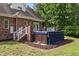 Charming backyard featuring a covered hot tub area, nestled amongst lush greenery and foliage at 5237 Christian Light Rd, Fuquay Varina, NC 27526