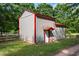 Well-maintained barn with red trim, white doors, and a practical design at 5237 Christian Light Rd, Fuquay Varina, NC 27526
