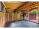This barn stall features wood plank walls, a black rubber floor, and water buckets at 5237 Christian Light Rd, Fuquay Varina, NC 27526