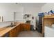 Basement kitchen features oak cabinets, a stainless-steel refrigerator, and a stainless sink at 5237 Christian Light Rd, Fuquay Varina, NC 27526