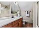 Bathroom with a wood vanity, medicine cabinet, and brown tile floor at 5237 Christian Light Rd, Fuquay Varina, NC 27526
