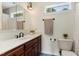 Well-lit bathroom with a dark wood vanity, a neutral towel, and tiled floors at 5237 Christian Light Rd, Fuquay Varina, NC 27526