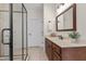 Bathroom showcasing a glass enclosed shower and wood vanity with a dark framed mirror and modern lighting at 5237 Christian Light Rd, Fuquay Varina, NC 27526