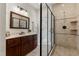 Bathroom with shower stall, dual lighting, vanity, and dark framed mirror at 5237 Christian Light Rd, Fuquay Varina, NC 27526