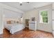 Inviting bedroom featuring hardwood floors, a ceiling fan, a window, and a walk-in nook at 5237 Christian Light Rd, Fuquay Varina, NC 27526