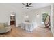 Main bedroom featuring a ceiling fan, neutral walls, hardwood floors, and ensuite bathroom access at 5237 Christian Light Rd, Fuquay Varina, NC 27526