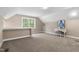 Carpeted upstairs bedroom with neutral walls and natural light from window at 5237 Christian Light Rd, Fuquay Varina, NC 27526