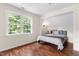 Cozy bedroom nook with hardwood floors, a window view, and a comforting color palette at 5237 Christian Light Rd, Fuquay Varina, NC 27526