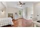 Bright bedroom features hardwood floors, a walk-in nook, a ceiling fan, and natural light at 5237 Christian Light Rd, Fuquay Varina, NC 27526
